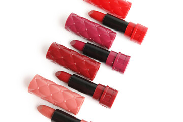 Different stylish lipsticks on white background