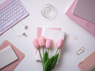 Feminine and cute white and pink computer workspace flat lay top view
