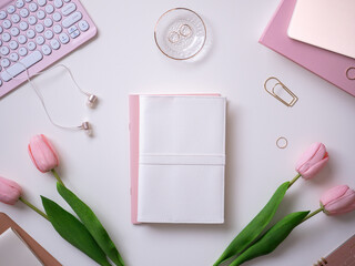 Feminine and cute white and pink computer workspace flat lay top view