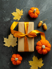 Seasonal holiday gift box with dried leaves and mini pumpkins
