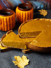 Traditional Thanksgiving pumpkin pie, two coffee cups