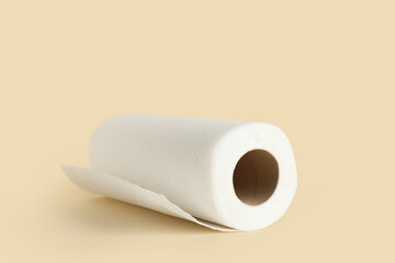 Roll of paper towels on beige background