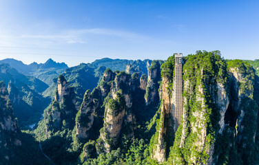 Unique outdoor glass elevator built on a sheer cliff among spectacular quartz-sandstone pillars in Hunan. majestic Zhangjiajie national forest park, Wulingyuan Scenic Area in China. © ABCDstock