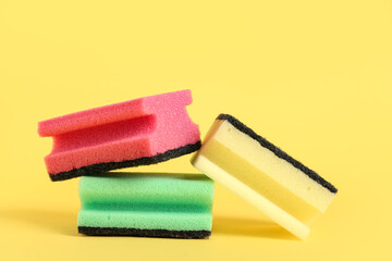 Cleaning sponges on yellow background