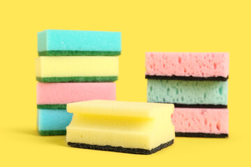 Cleaning sponges on yellow background