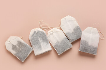 Tea bags on beige background