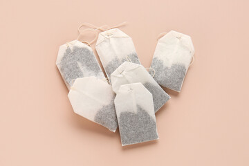 Tea bags on beige background
