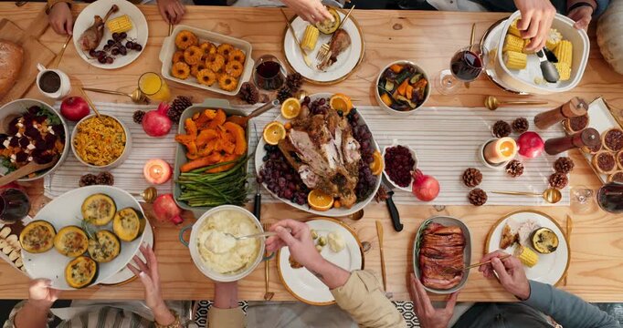 Thanksgiving, dinner and hands with meal, dining room or together for reunion on festive celebration. Above, family and people with food for gathering, time lapse and eating feast on holiday in house