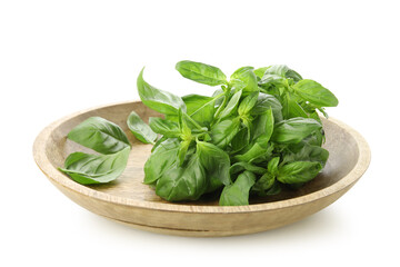 Wooden plate with fresh basil leaves on white background