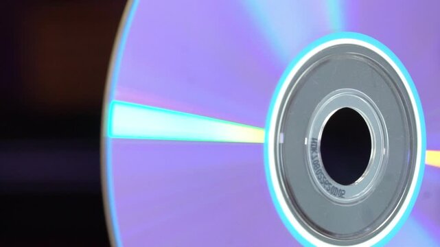 DVD CD with purple reflection in macro close-up and black background