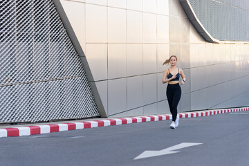Fit woman engages in outdoor sport exercise workout, people see her dedication, showing strong athletic body staying fit on urban street with modern building architecture