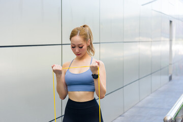 Workout for fit sport woman, outdoor exercise with resistance band builds strength, full body...