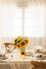 Elegant table serving with plates, glasses and beautiful sunflowers