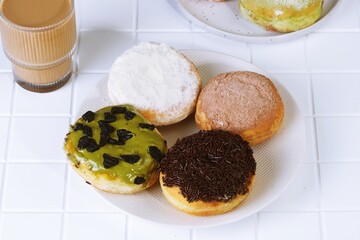 Assorted Donuts with Toppings on White Plate