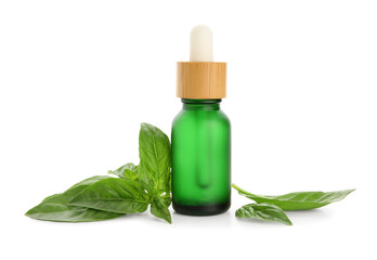Bottle of basil essential oil isolated on white background, closeup