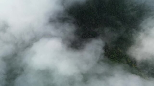 Drone footage shows dense forests shrouded in thick fog and slowly moving clouds, depicting the pristine natural beauty of Sukoharjo, Central Java, Indonesia, on Sunday, June 8, 2025.