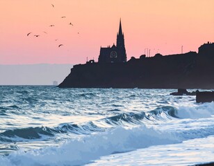 Silhouette of a Gothic church on a cliff overlooking the ocean at sunset with birds flying