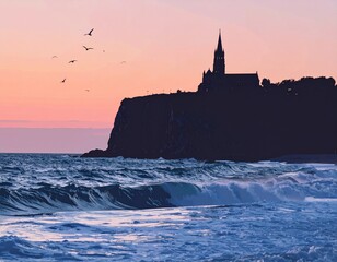 Serene coastal landscape with a historic church silhouetted on a cliff above the ocean at sunset.