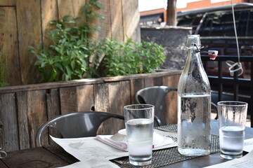glasses and bottle of water on table at restaurant