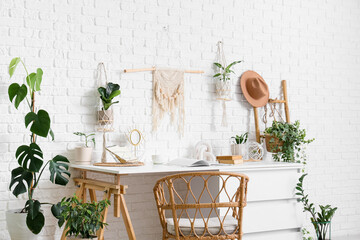 Interior of office with workplace, ladder and houseplants