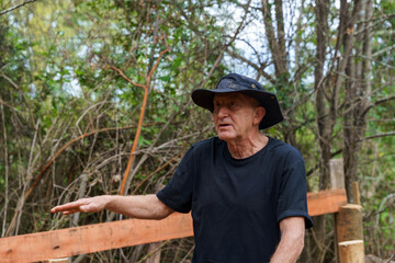 Senior man gesturing with hand explaining outdoor details