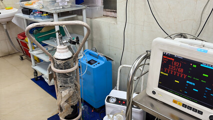 emergency medical equipment with oxygen tank and ventilator accessories at intensive care unit