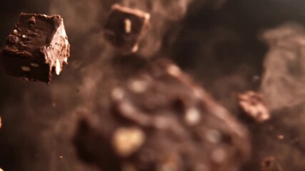 Falling chocolate squares with peanuts in a smoky artistic composition - Powered by Adobe