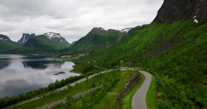 Vehicles parked at scenic Bergsbotn viewpoint overlooking arctic fjord, aerial