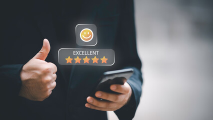 Businessman using smartphone to give five-star positive review with smiley face icon, Customers give 5-star reviews,symbolizing excellent customer feedback, and user satisfaction in digital service.