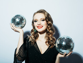 Beautiful young woman holding disco ball