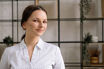 Portrait of a young woman in an office. Business and people concept.