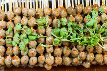 Grilled beef meatballs on sticks with dipping sauce. Thai street food that is famous all over the world.