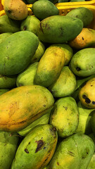 Fresh Green Mangoes in a Basket for Sale