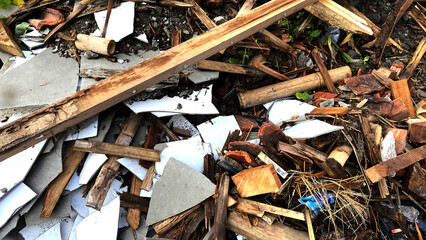 Debris and Trash Pile of Wooden Planks Broken Tiles and Plastic Waste in Outdoor Environment