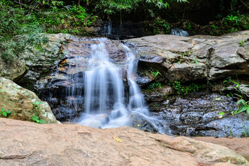 Beautiful Small Waterfall in Green Forest in jungle at Huay U-Mong Nature Trail Chiang Mai, Northern Thailand