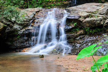 Beautiful Small Waterfall in Green Forest in jungle at Huay U-Mong Nature Trail Chiang Mai, Northern Thailand