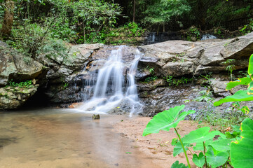 Beautiful Small Waterfall in Green Forest in jungle at Huay U-Mong Nature Trail Chiang Mai, Northern Thailand