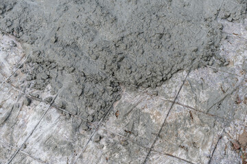 Wet Concrete Being Poured Over Wire Mesh Reinforcement