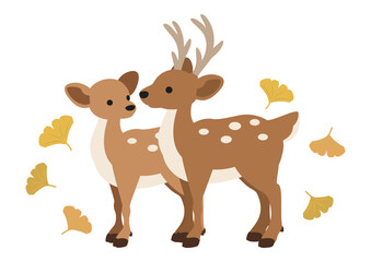 イチョウの葉が舞う中で寄り添う二頭の鹿