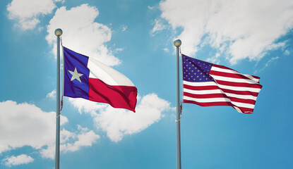 Texas state flag and American flag waving in the wind on flagpoles. Blue sky background and white...