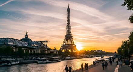 Naklejka premium Iconic Eiffel Tower illuminated by a golden sunset over the Seine River, with people strolling along the embankment and boats on the water, showcasing Parisian grandeur.