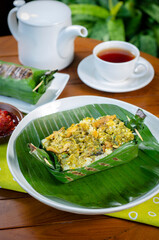 Grilled rice with shredded chicken and green chilies, wrapped in banana leaves, traditional Indonesian food
