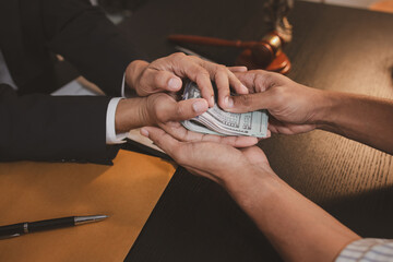 A professional lawyer discussing legal matters with a client in an office, providing legal advice...