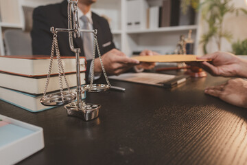 A professional lawyer discussing legal matters with a client in an office, providing legal advice and document review services, symbolizing justice, trust, and professional consultation.