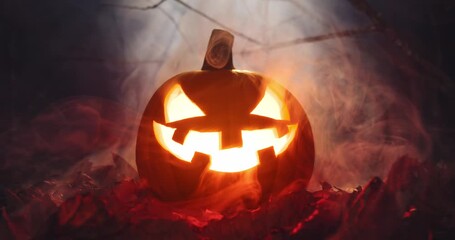 Scary carved face of a Halloween jack o lantern pumpkin glowing brightly covered ghostly smoke and fog. Haunted atmosphere around creepy pumpkin in eerie wilderness for spooky Halloween background. - Powered by Adobe