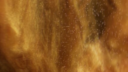 Shimmering ink. Dust blur fluid. Golden particles flow spill shiny pigment in water. Sparkling abstract cloud explosion black background. - Powered by Adobe