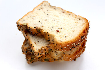 Sliced multigrain bread topped with pumpkin seeds, sunflower seeds, sesame, and black sesame.