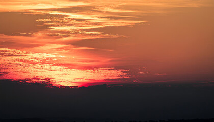 Vibrant sunset sky with fiery clouds and golden hues