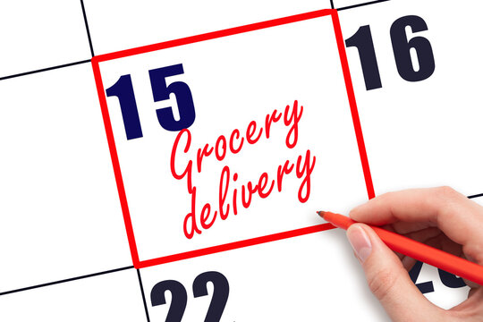 15 th day of the month.  Hand writing Grocery delivery reminder and drawing red frame on calendar with red pen on white background. Business concept. Planning and scheduling