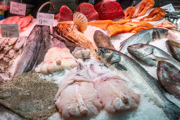 Fish monger with a catch of fresh fish seen in Barcelona, Spain